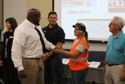 Highway construction graduates shaking hands